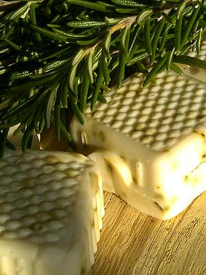 Handmade Rosemary Essential Oil Soap on wood.